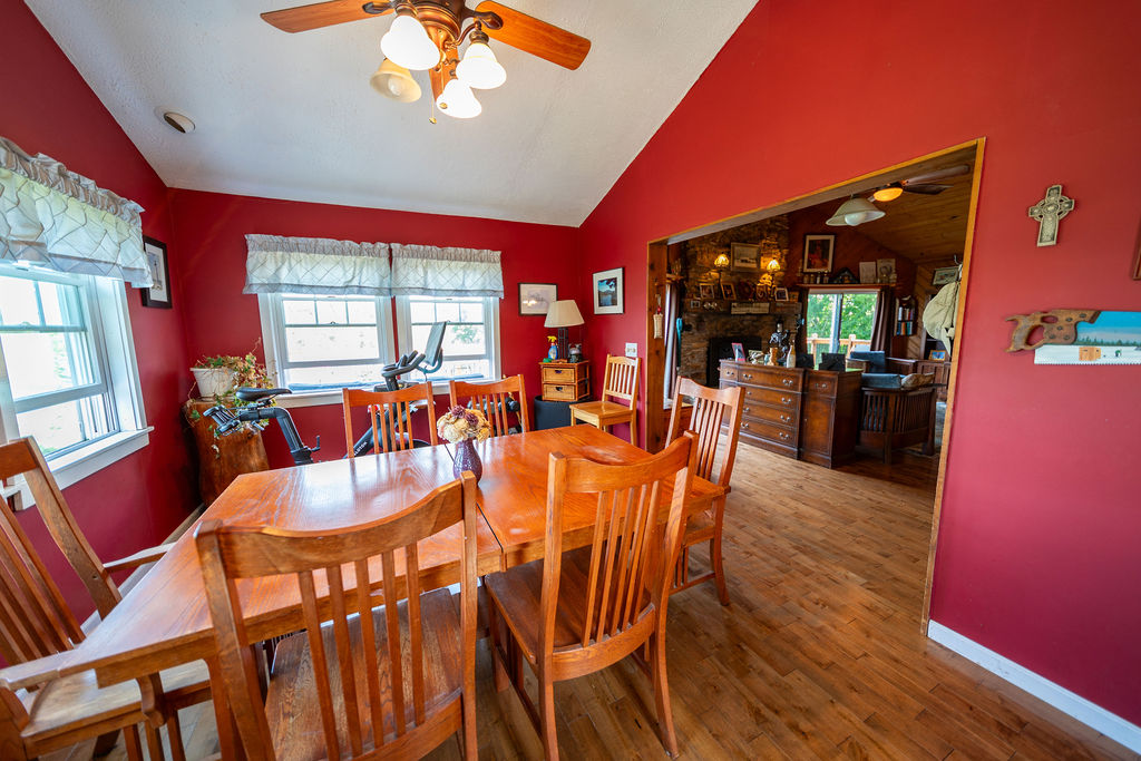 Red dining room with oak table open to the fireplace living room