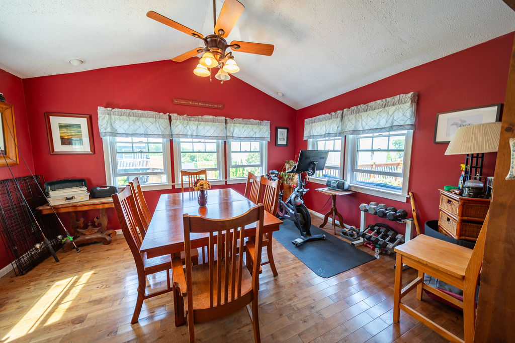 Bright bonus room with river views, wood floors and vaulted ceiling