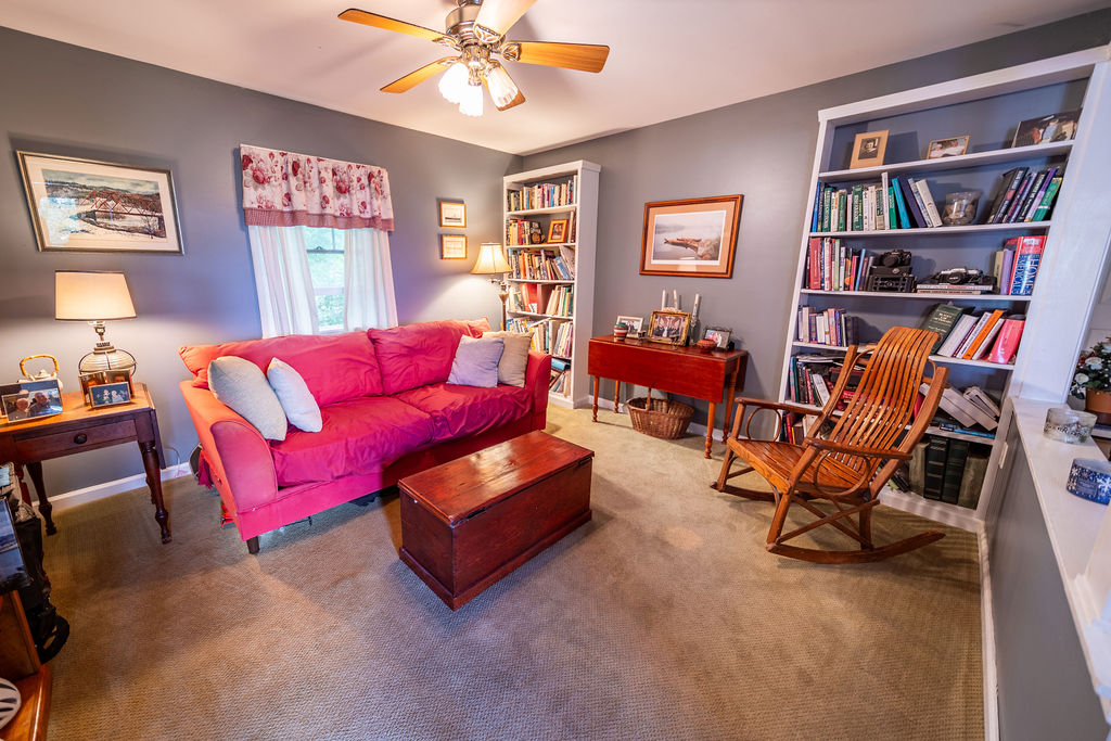 Cozy reading room with built-in bookshelves and rocking chair