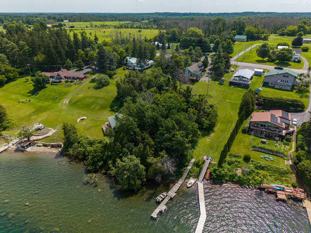 Aerial view of the neighborhood shoreline and docks along the river