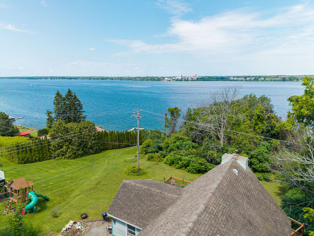 Aerial view over the roof toward the St. Lawrence River and shoreline
