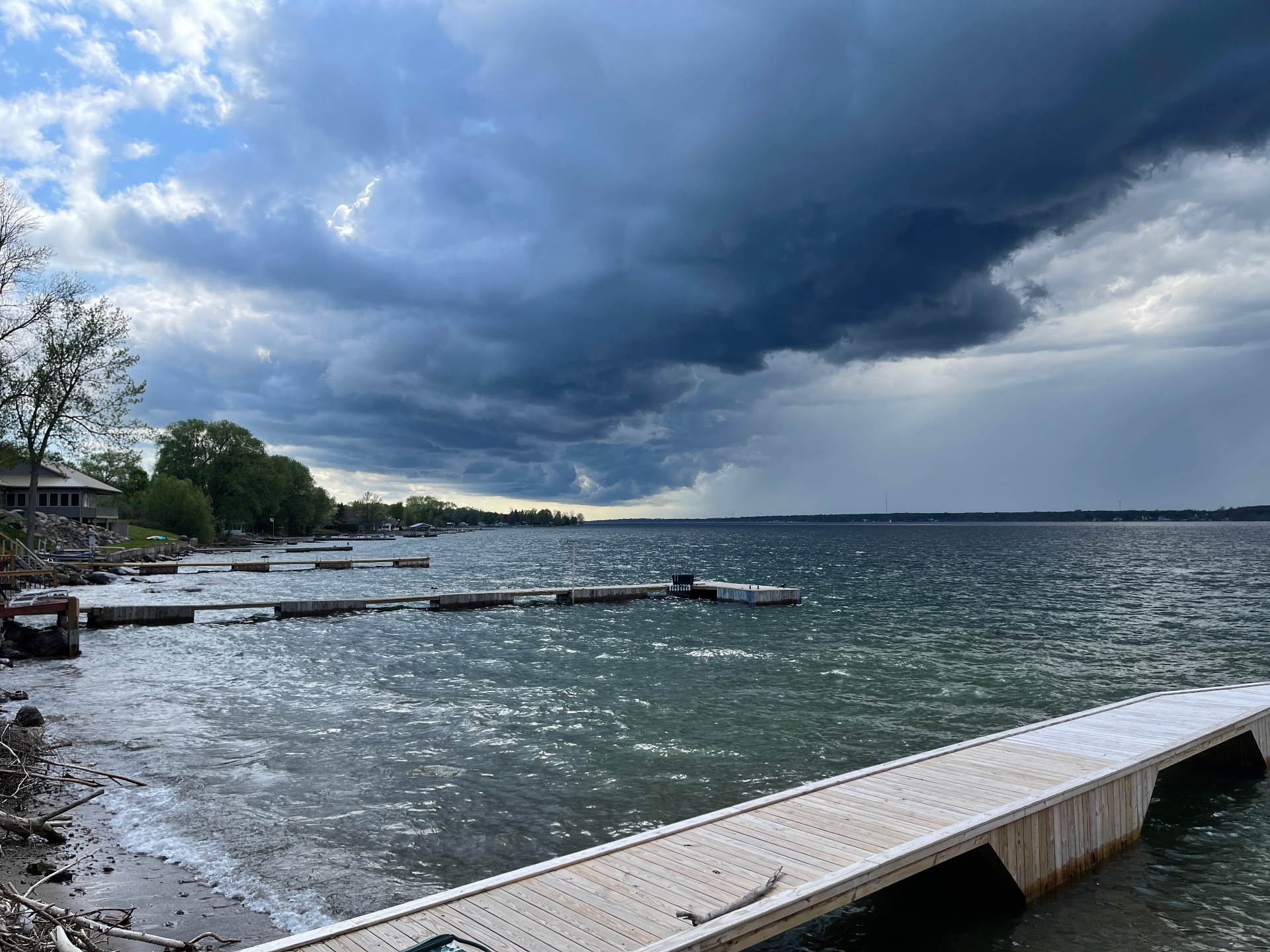 Dramatic storm clouds rolling over the docks on the river